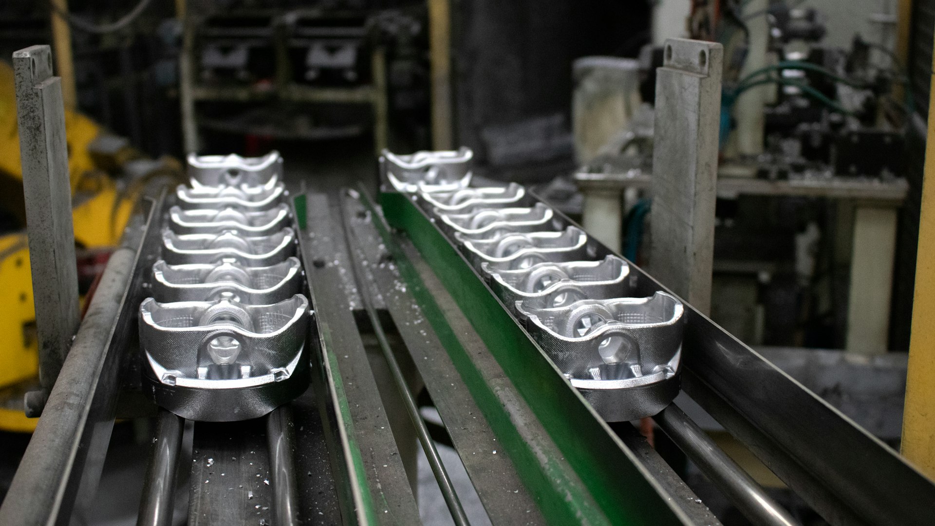 A conveyor belt with a bunch of metal objects on it